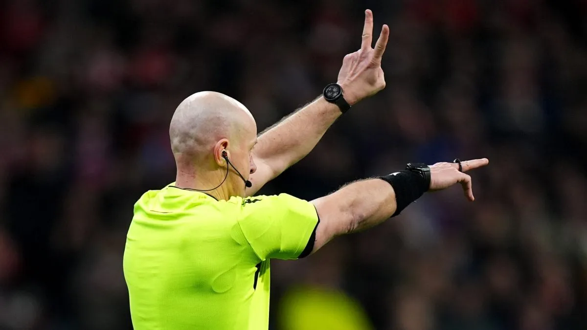 Referee Szymon Marciniak gestures as the second penalty kick for Atletico de Madrid, taken by Julian Alvarez (not pictured), is ruled out following a VAR Review for an improper kick during the UEFA Champions League 2024/25 Round of 16 second leg match between Atletico de Madrid and Real Madrid C.F. at Estadio Metropolitano on March 12, 2025 in Madrid, Spain.