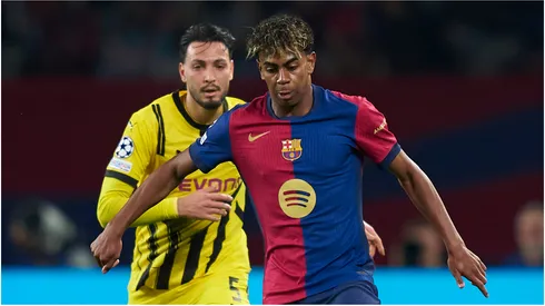Lamine Yamal of FC Barcelona competes for the ball with Ramy Bensebaini of Borussia Dortmund