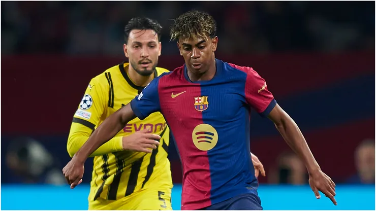 Lamine Yamal of FC Barcelona competes for the ball with Ramy Bensebaini of Borussia Dortmund