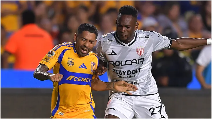 Javier Aquino of Tigres fights for the ball with Diber Cambindo of Necaxa