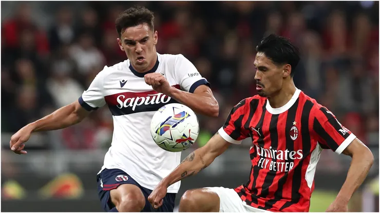 Tijjani Reijnders of AC Milan is challenged by Nikola Moro of Bologna