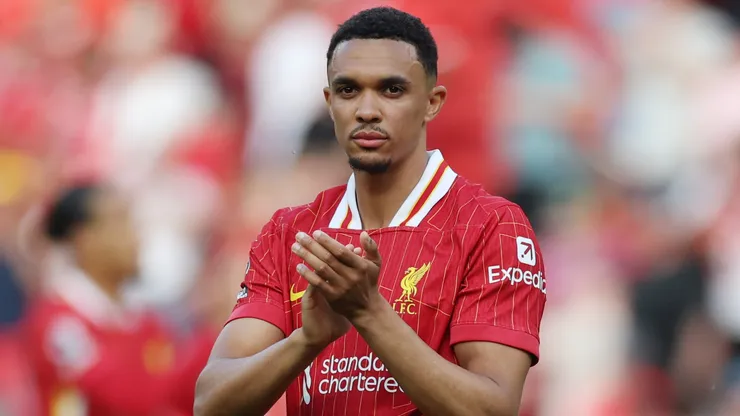 Trent Alexander-Arnold of Liverpool applauds the fans after the draw in the Premier League match between Liverpool FC and Arsenal FC at Anfield on May 11, 2025 in Liverpool, England.