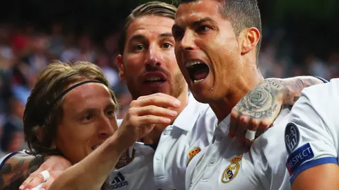 Cristiano Ronaldo of Real Madrid (R) celebrates as he scores their first goal with team mates Luka Modric and Sergio Ramos during the UEFA Champions League semi final first leg match between Real Madrid CF and Club Atletico de Madrid at Estadio Santiago Bernabeu on May 2, 2017 in Madrid, Spain.