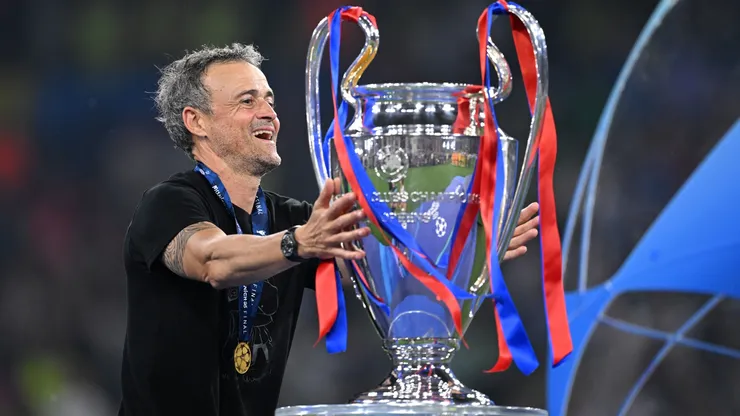 Luis Enrique, Head Coach of Paris Saint-Germain, reacts as he walks past the UEFA Champions League trophy after collecting his winners medal after defeating FC Internazionale, to secure Paris Saint-Germain's first ever UEFA Champions League title in the club's history and a record UEFA Champions League Final winning scoreline of 5-0, following the UEFA Champions League Final 2025 between Paris Saint-Germain and FC Internazionale Milano at Munich Football Arena on May 31, 2025 in Munich, Germany.