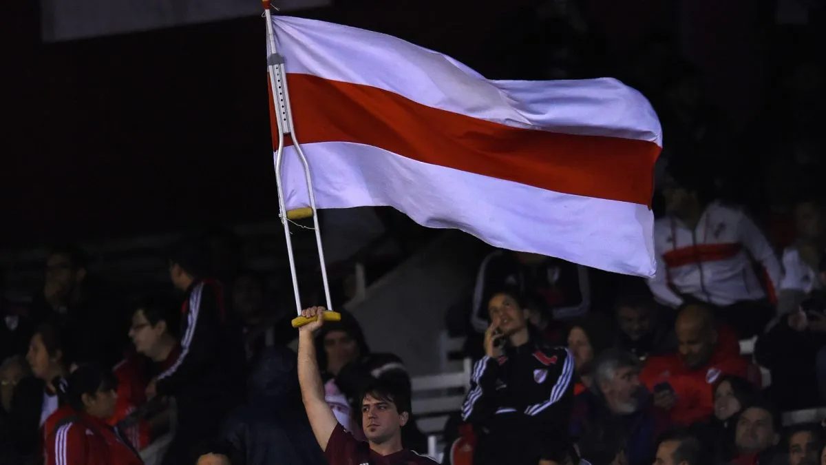 A fan of River Plate waves a flag with a crutch prior to the semi final first leg match between River Plate and Boca Juniors as part of Copa CONMEBOL Libertadores 2019. (Source: Marcelo Endelli/Getty Images)