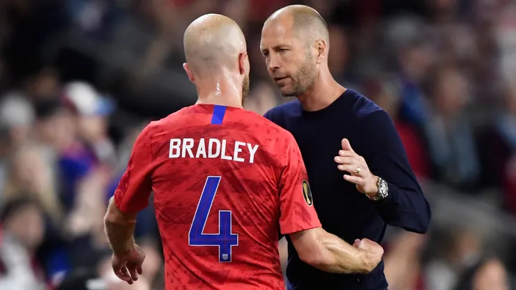 Head coach Gregg Berhalter of the United States welcomes Michael Bradley #4 back to the bench after a substitution during the second half of the CONCACAF Gold Cup match in 2019.