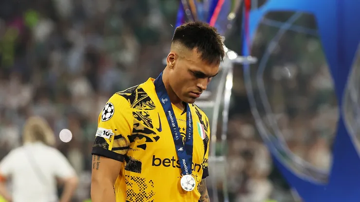 Lautaro Martinez of FC Internazionale looks dejected as he walks past the UEFA Champions League trophy after defeat to Paris Saint-Germain after the UEFA Champions League Final 2025 between Paris Saint-Germain and FC Internazionale Milano at Munich Football Arena on May 31, 2025 in Munich, Germany.