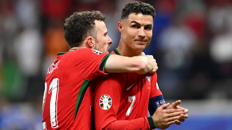 Diogo Jota and Cristiano Ronaldo of Portugal celebrate following the team's victory in the penalty shoot out during the UEFA EURO 2024 round of 16 match between Portugal and Slovenia at Frankfurt Arena on July 01, 2024 in Frankfurt am Main, Germany.
