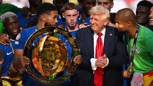 Reece James #24 of Chelsea FC holds the FIFA Club World Cup trophy after their team's victory as U.S. President Donald Trump interacts with Robert Sanchez #1 of Chelsea FC following the FIFA Club World Cup 2025 Final match between Chelsea FC and Paris Saint-Germain at MetLife Stadium on July 13, 2025 in East Rutherford, New Jersey.