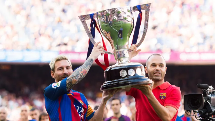 Lionel Messi and Andres Iniesta of FC Barcelona lift up the Spanish La Liga 2015-2016 season trophy before the La Liga match between FC Barcelona and Real Betis Balompie at Camp Nou on August 20, 2016.