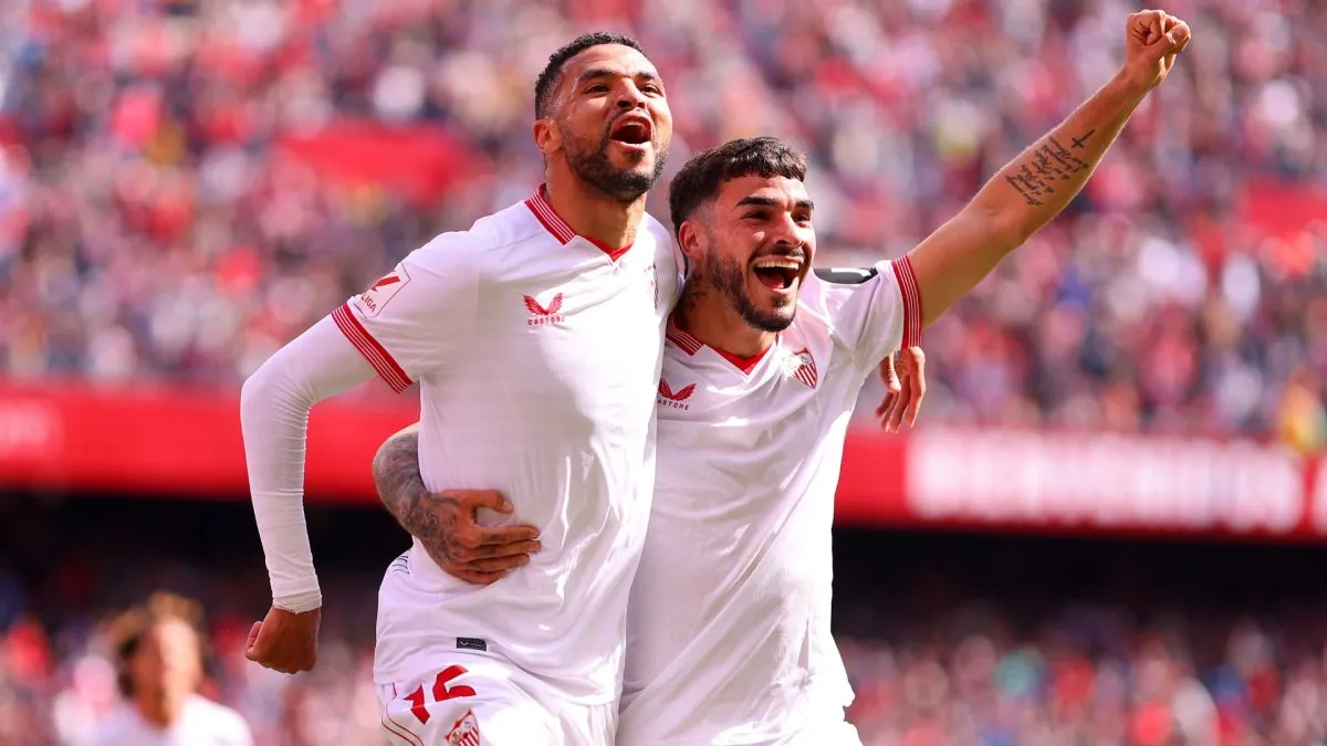 Yousseff En-Nesyri of Sevilla FC celebrates scoring his team’s second goal with team mate Isaac Romero during the LaLiga EA Sports match in 2024. (Source: Fran Santiago/Getty Images)