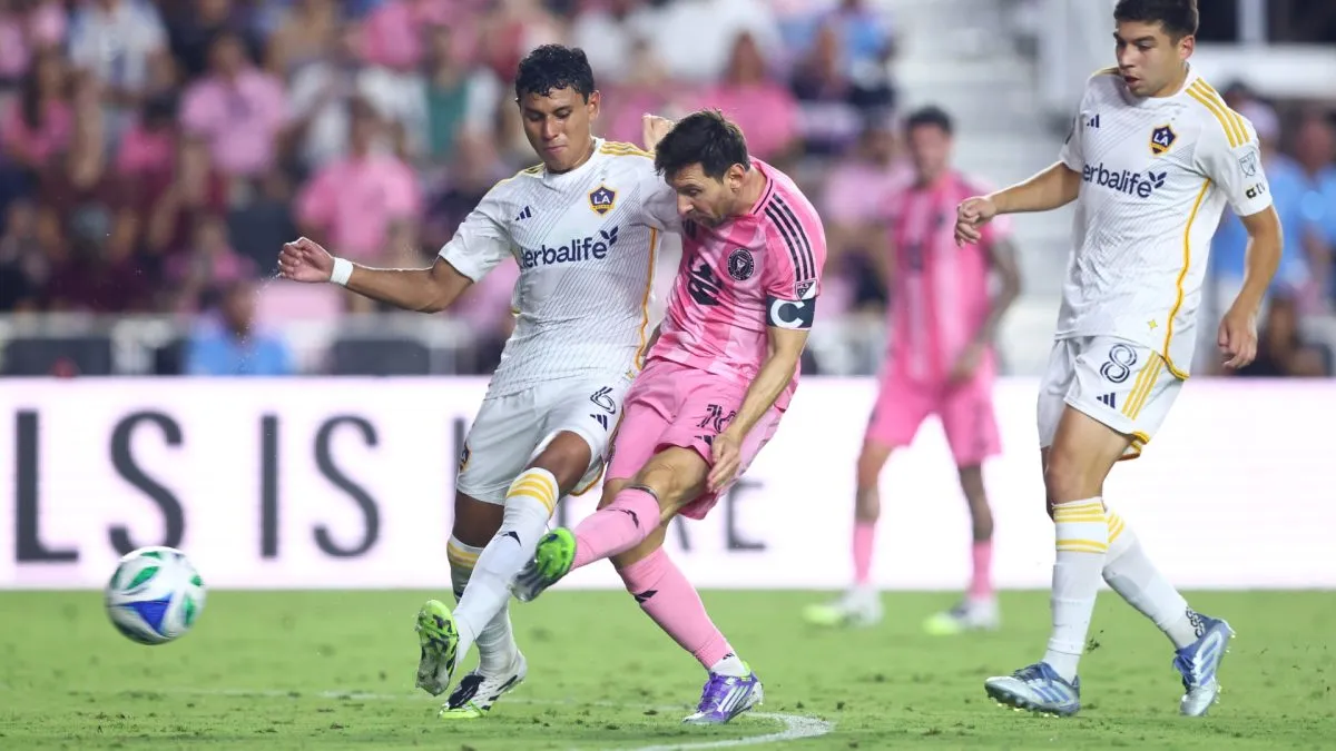 Lionel Messi #10 of Inter Miami CF scores the team's second goal whilst under pressure from Edwin Cerrillo #6 of LA Galaxy during the MLS match between Inter Miami CF and LA Galaxy at Chase Stadium on August 16, 2025 in Fort Lauderdale, Florida.