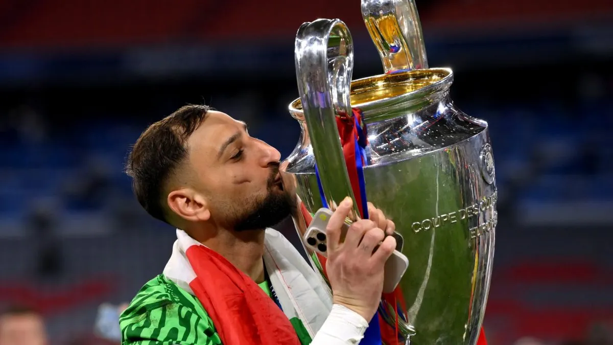 Gianluigi Donnarumma of Paris Saint-Germain kisses the UEFA Champions League trophy after his team's victory.