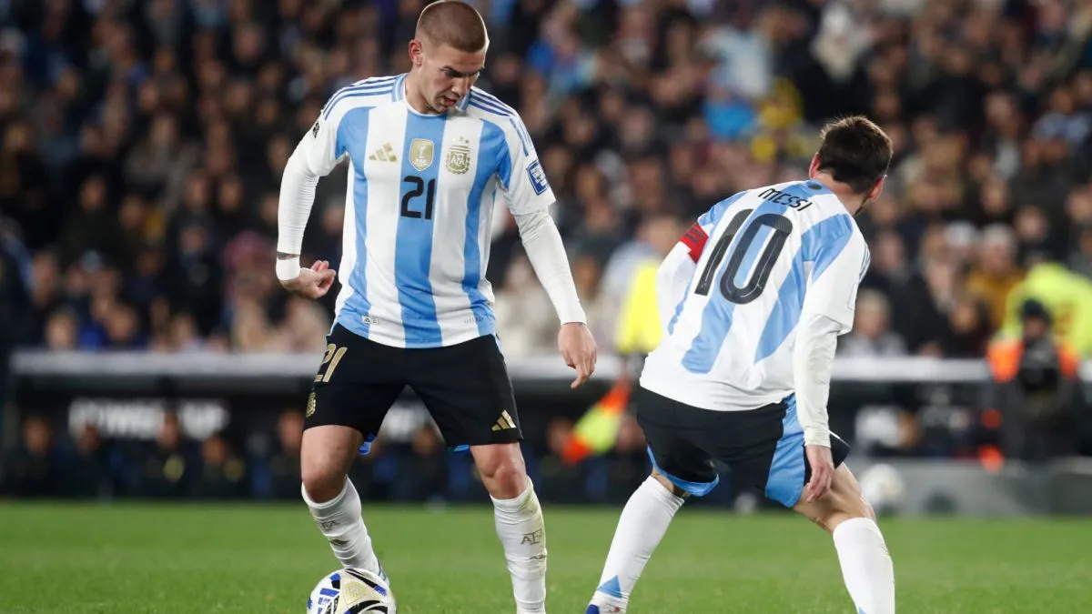 Franco Mastantuono of Argentina controls the ball next to Lionel Messi.