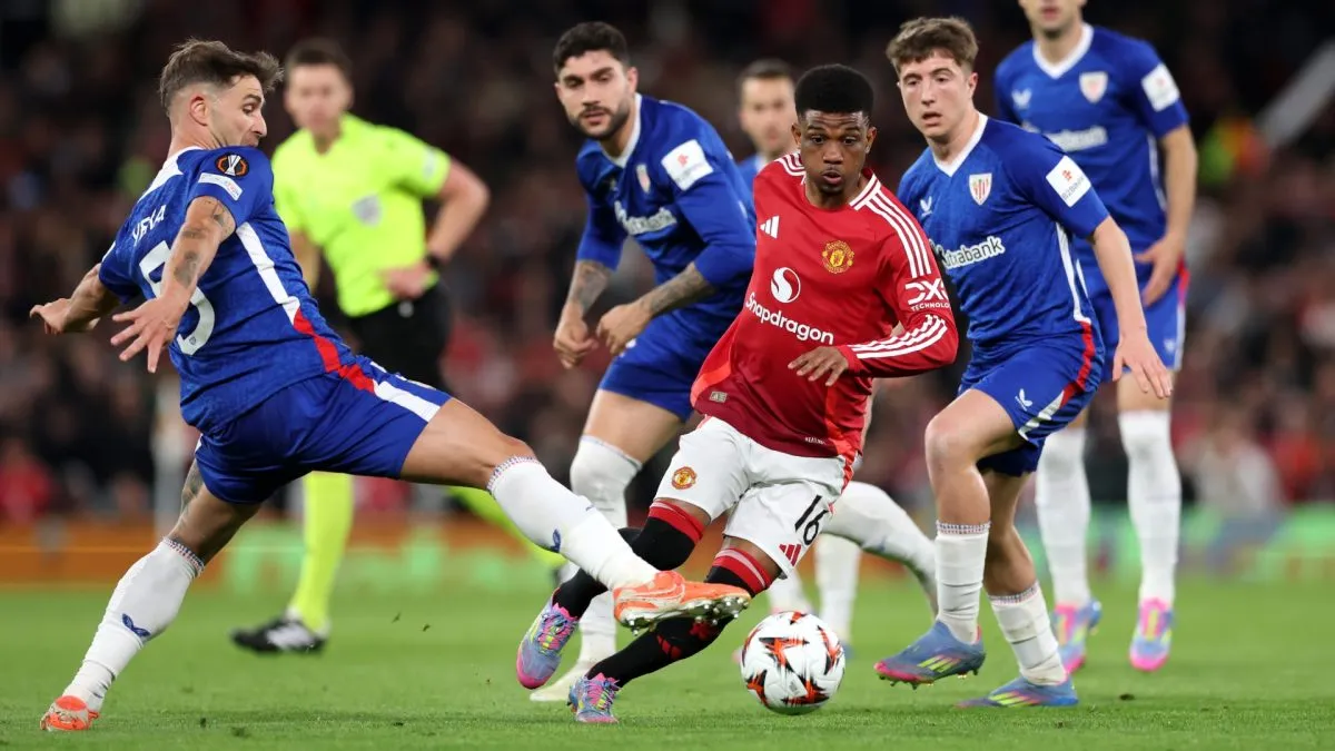 Amad Diallo of Manchester United runs with the ball whilst under pressure from Yeray of Athletic Club during the UEFA Europa League 2024/25 Semi Final Second Leg match between Manchester United and Athletic Club.