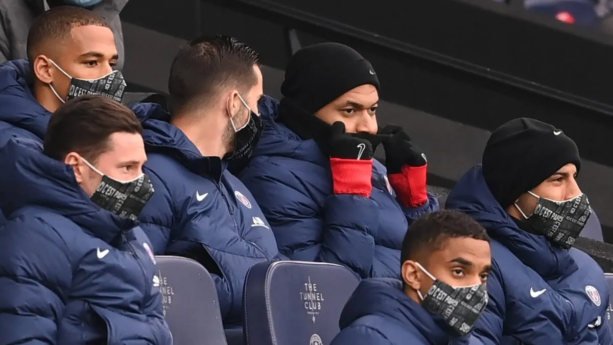 Kylian Mbappe looks on from the bench during the 2020-21 UEFA Champions League Semi Final Second Leg match between Manchester City and Paris Saint-Germain.