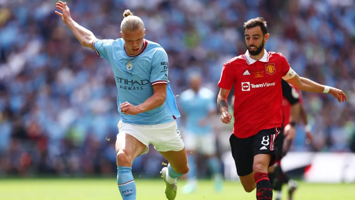 Erling Haaland of Manchester City passes the ball whilst under pressure from Bruno Fernandes of Manchester United during the Emirates FA Cup Final.