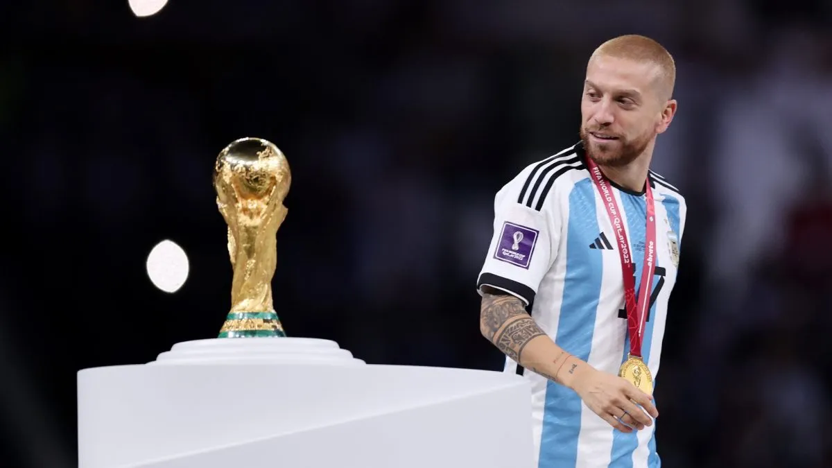 Alejandro Gomez of Argentina walks past the The FIFA World Cup Qatar 2022 Winner’s Trophy.