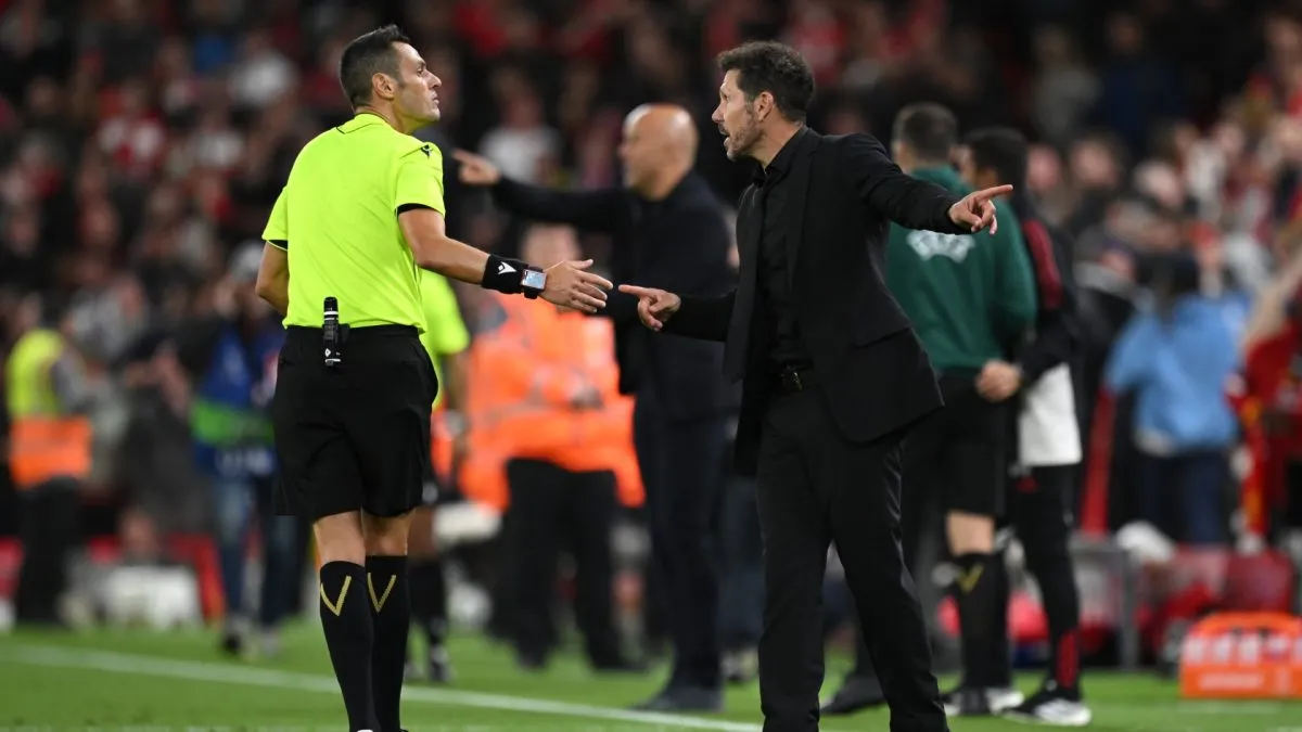 Diego Simeone, Head Coach of Atletico de Madrid, clashes with referee Maurizio Mariani during the UEFA Champions League 2025/26 League Phase MD1 match between Liverpool FC and Atletico de Madrid.