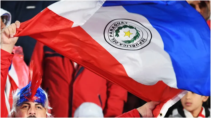 A fan of Paraguay waves a flag