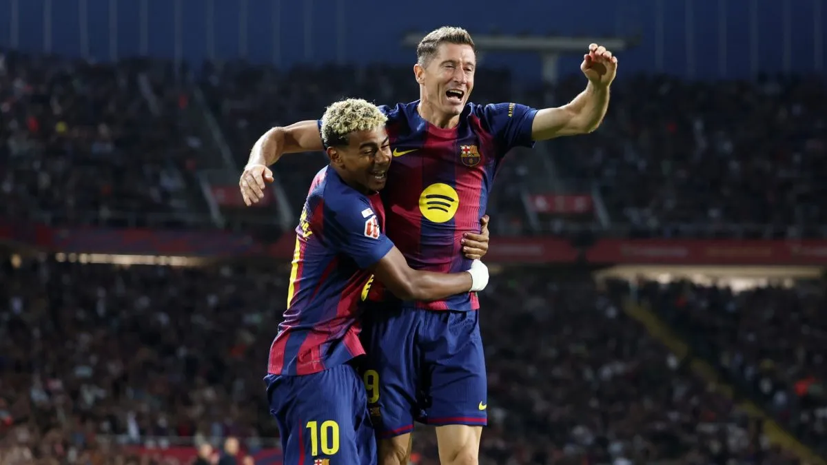 Robert Lewandowski of FC Barcelona (R) celebrates scoring his team's second goal with teammate Lamine Yamal (L) during the LaLiga EA Sports match between FC Barcelona and Real Sociedad.