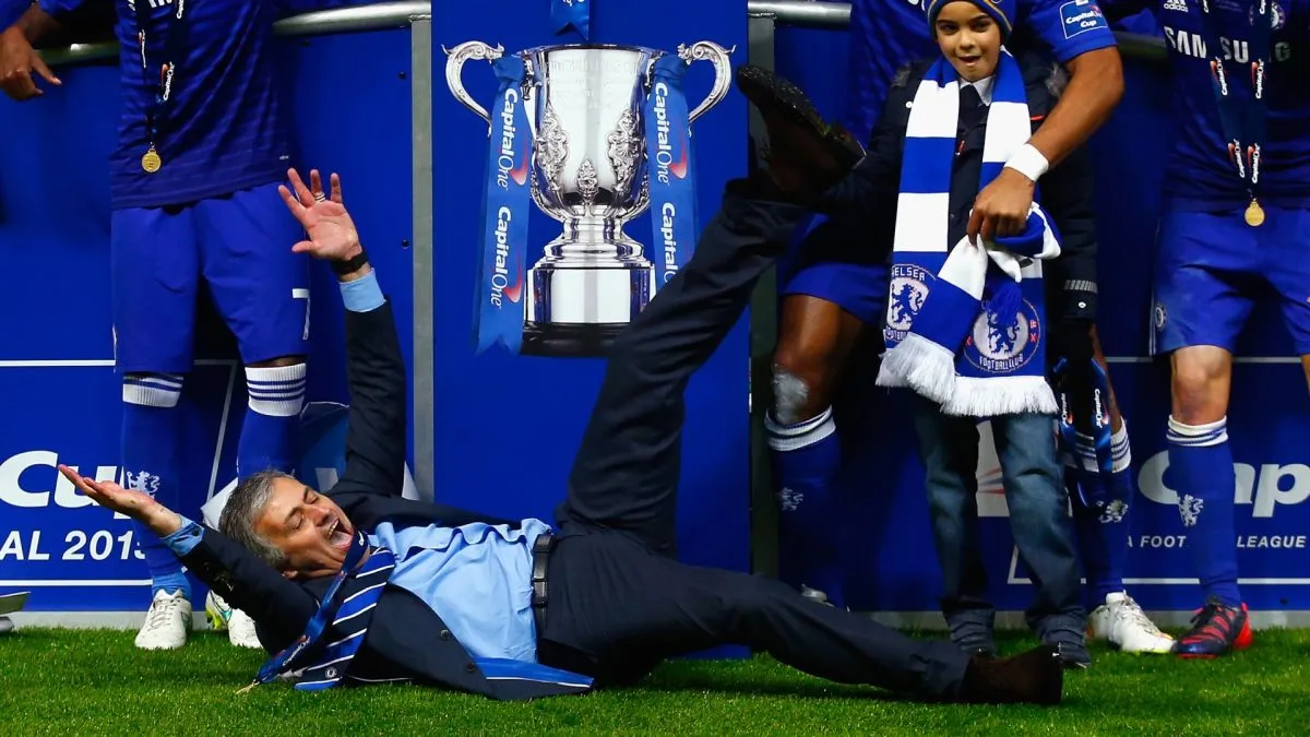 Manager Jose Mourinho of Chelsea lies on the pitch as Chelsea celebrate with the trophy during the Capital One Cup Final match.