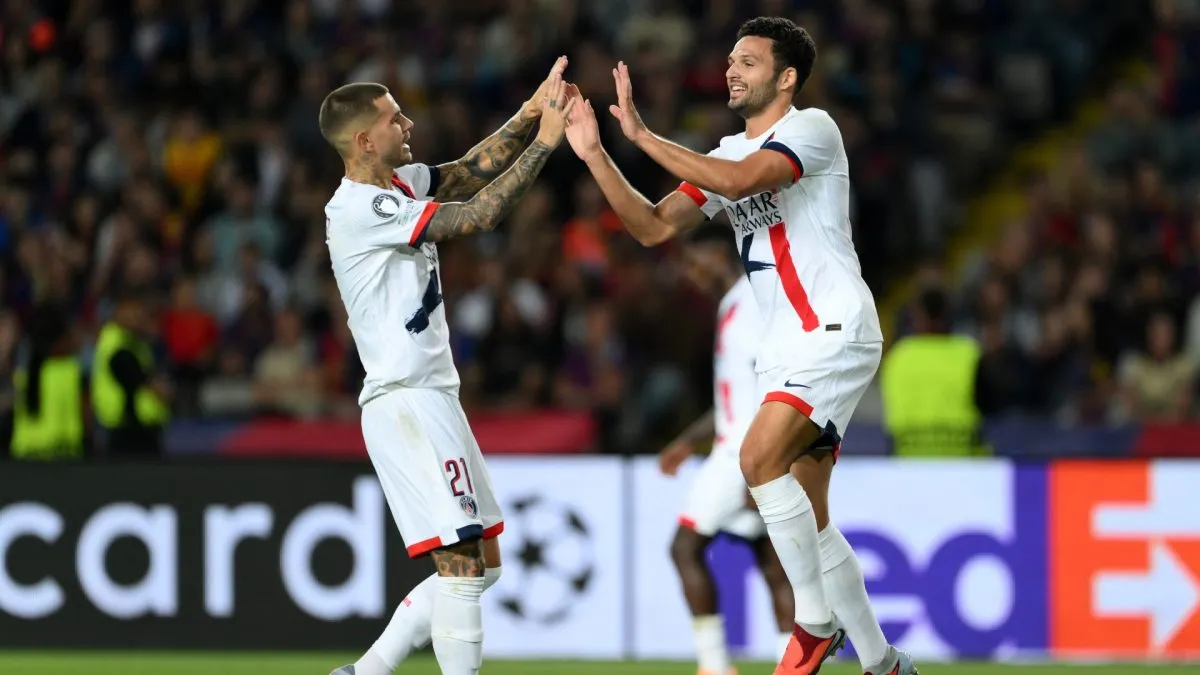 Goncalo Ramos of Paris Saint-Germain celebrates with teammate Lucas Hernandez after scoring his team's second goal against FC Barcelona.