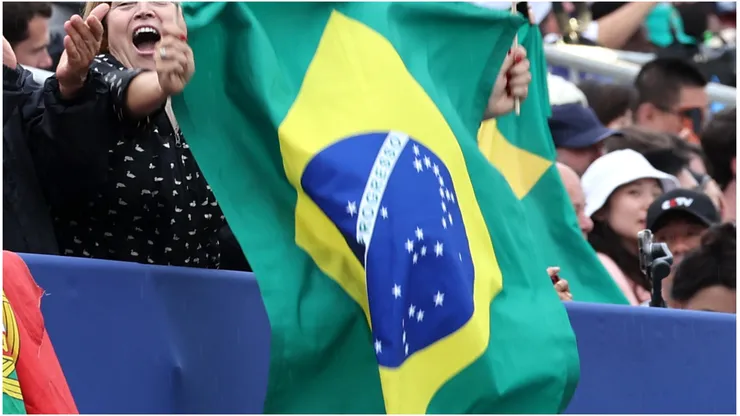 Fans wave the national flag of Brazil