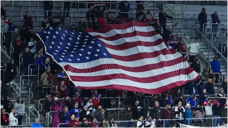 Fans of the United States hold a flag