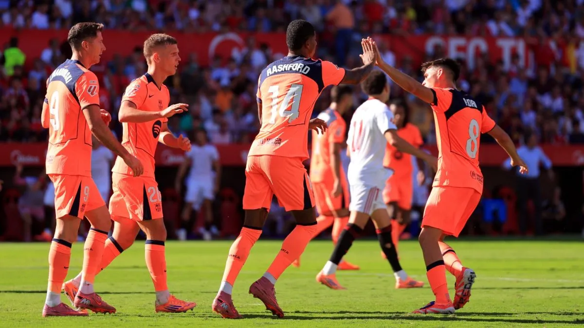 Marcus Rashford of FC Barcelona celebrates scoring his team's first goal with teammate Pedri during the LaLiga EA Sports match between Sevilla FC and FC Barcelona at Estadio Ramon Sanchez Pizjuan on October 05, 2025 in Seville, Spain.