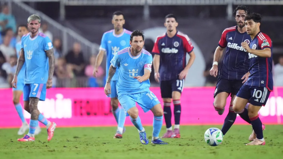 Lionel Messi #10 of Inter Miami CF and Carles Gil #10 of the New England Revolution run for the ball during the MLS match between Inter Miami CF and New England Revolution.