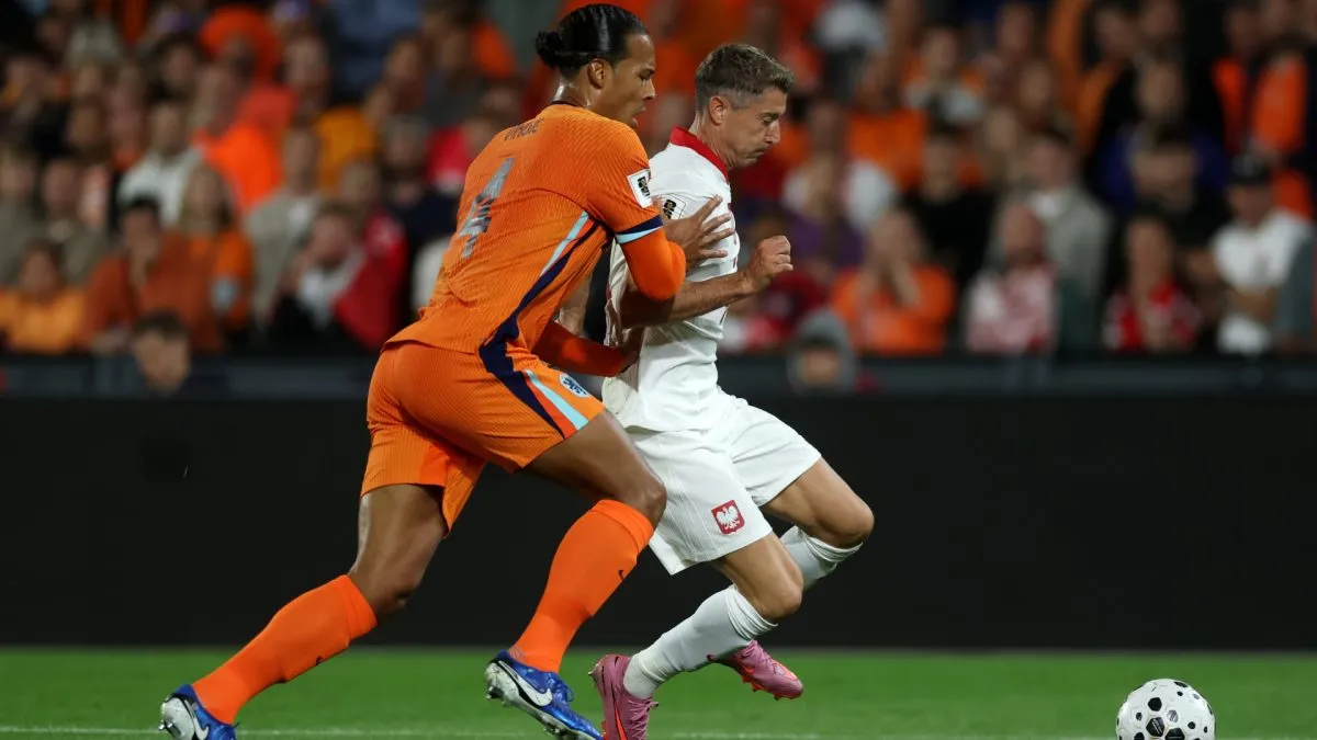 Robert Lewandowski of Poland gets past Virgil van Dijk of the Netherlands.