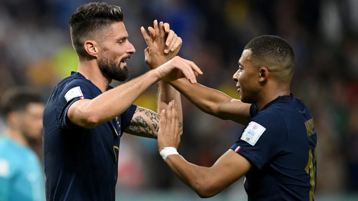 France' Olivier Giroud celebrates with Kylian Mbappe