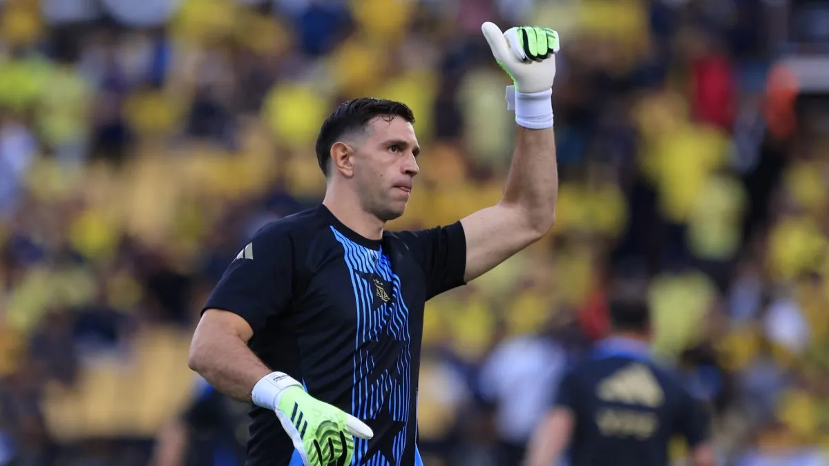Emiliano Martínez of Argentina waves fans during warm-ups.
