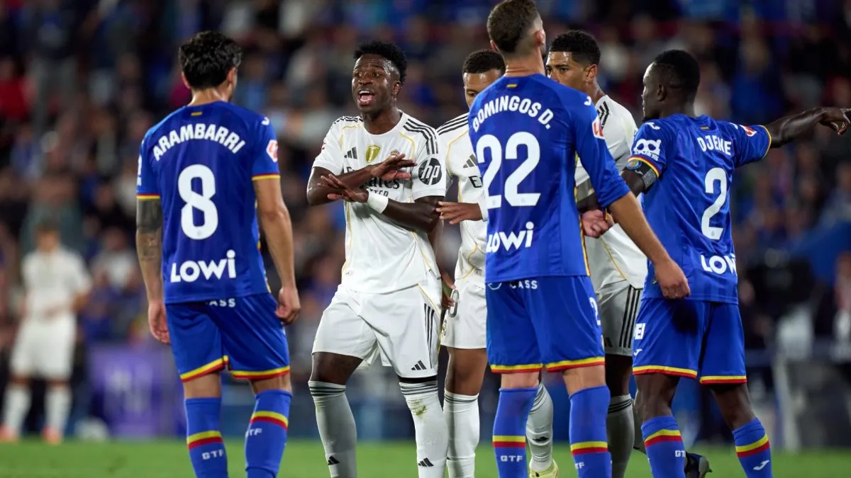 Vinicius Junior of Real Madrid argues with Mauro Arambarri of Getafe.
