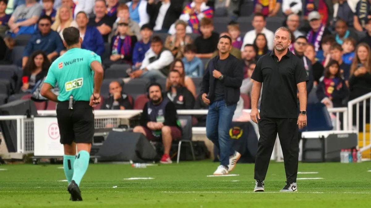 Referee Jesus Gil Manzano shows a red card to Hansi Flick during the match between Barcelona and Girona.