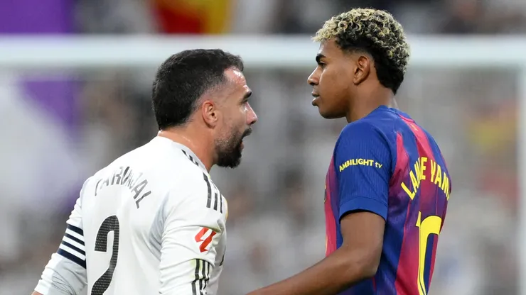 Dani Carvajal of Real Madrid clashes with Lamine Yamal of FC Barcelona.