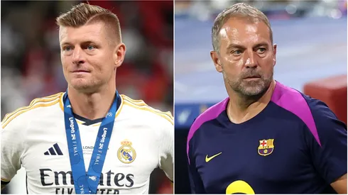 Toni Kroos of Real Madrid and Hansi Flick, Head Coach of FC Barcelona, looks on.