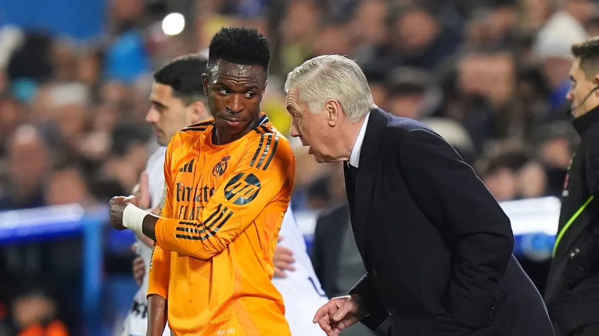 Carlo Ancelotti, Head Coach of Real Madrid, speaks with Vinicius Junior.