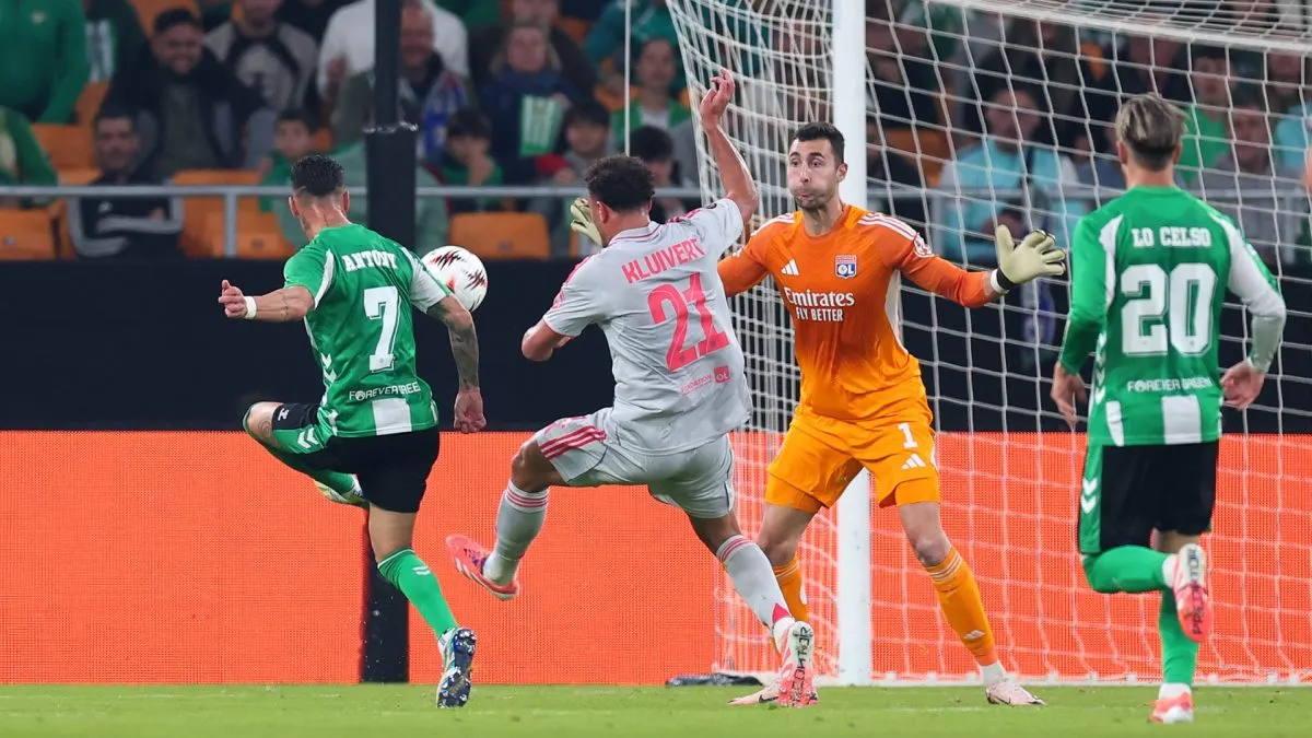 Antony of Real Betis scores his team's second goal against Olympique Lyonnais.