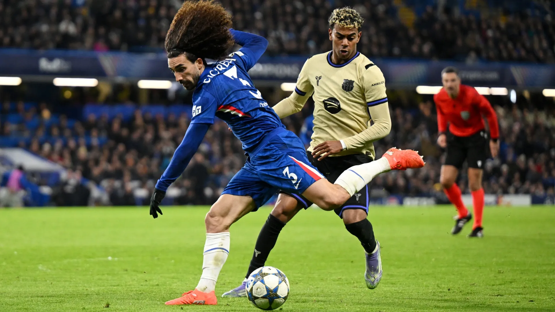 Marc Cucurella of Chelsea runs with the ball whilst under pressure from Lamine Yamal of FC Barcelona.
