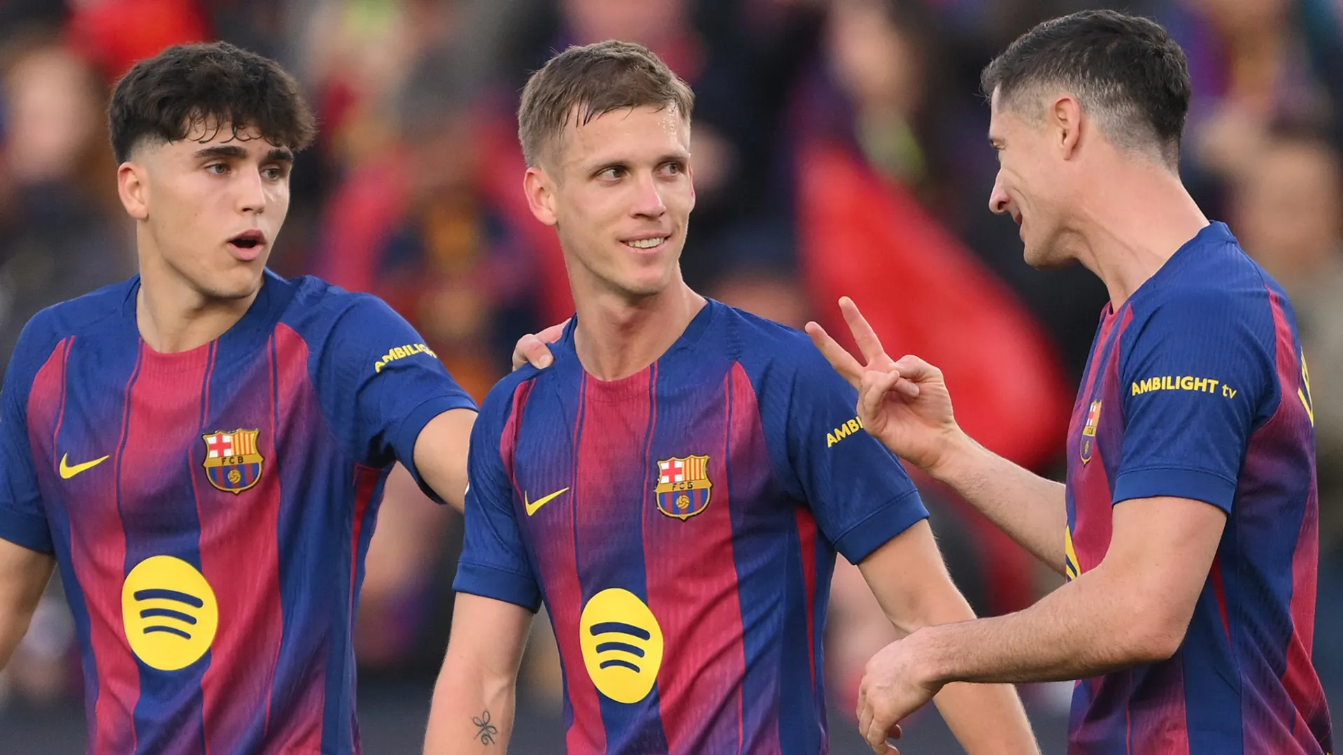 Barcelona stars Pau Cubarsi (L), Dani Olmo and Robert Lewandowski (r) talking