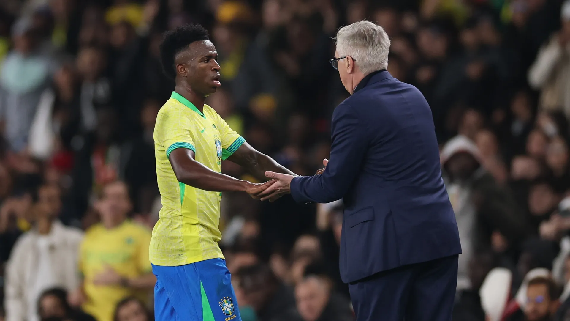 Carlo Ancelotti greets Vinicius Junior of Brazil after being subbed.