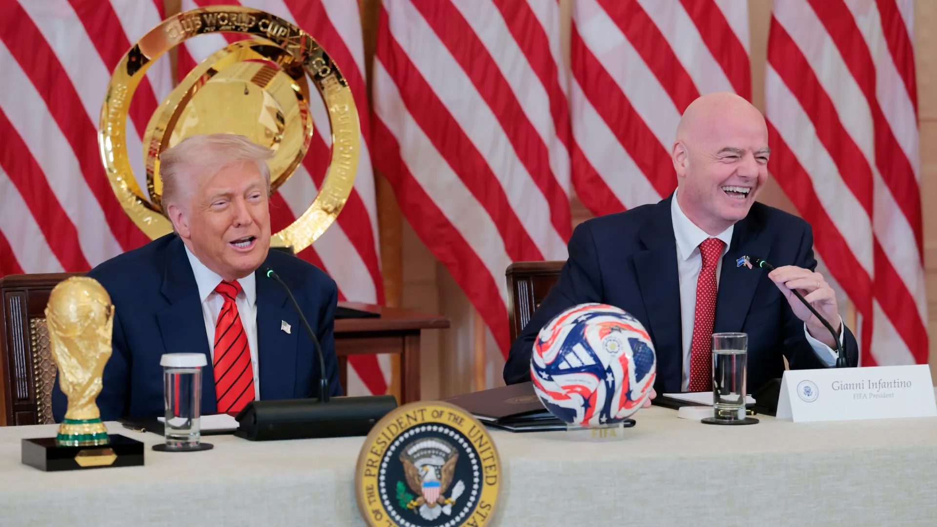 President Donald Trump speaks alongside FIFA Gianni Infantino during a meeting with the White House Task Force.
