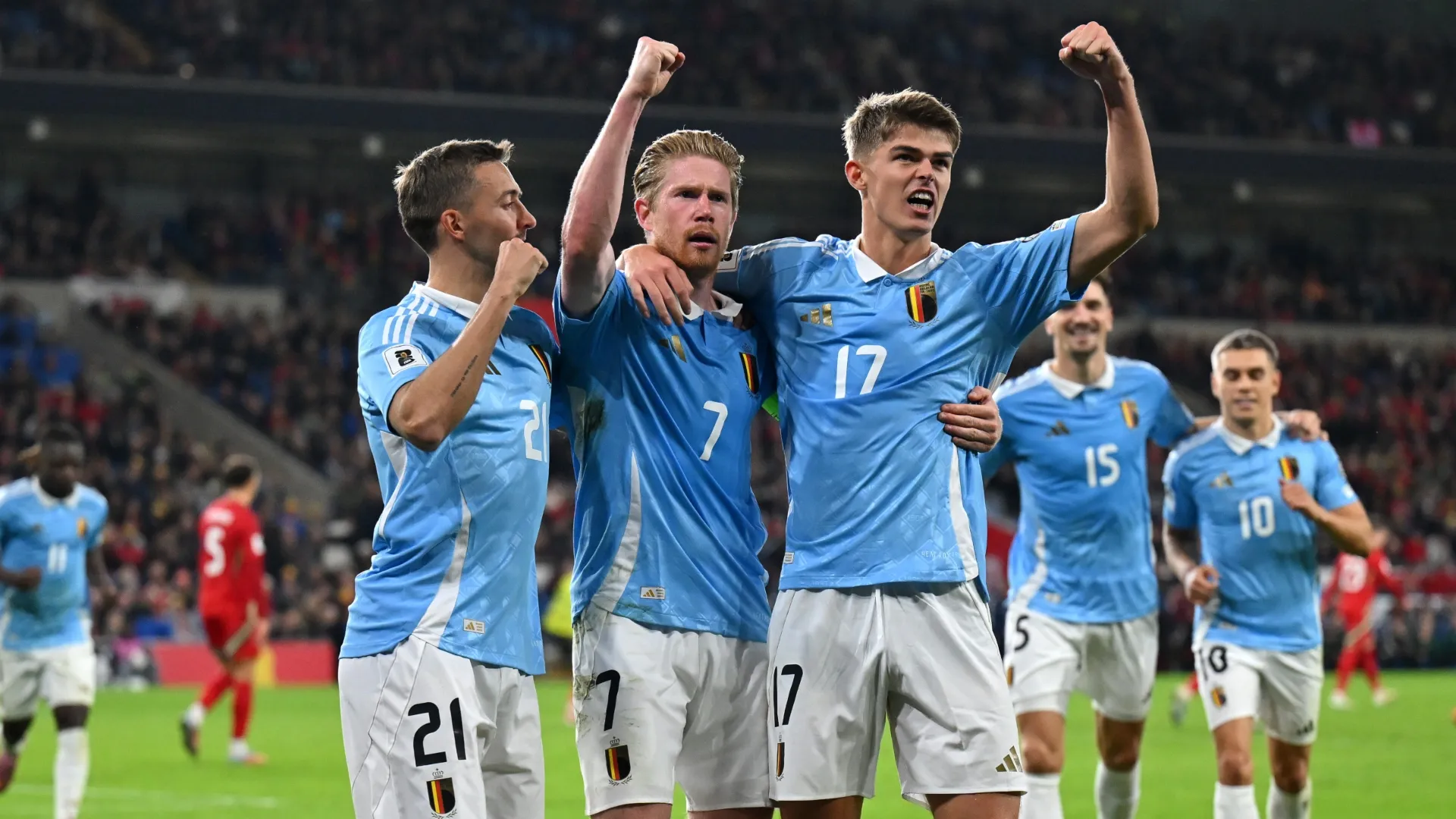 Kevin De Bruyne of Belgium celebrates with teammates Timothy Castagne and Charles De Ketelaere after scoring against Wales.