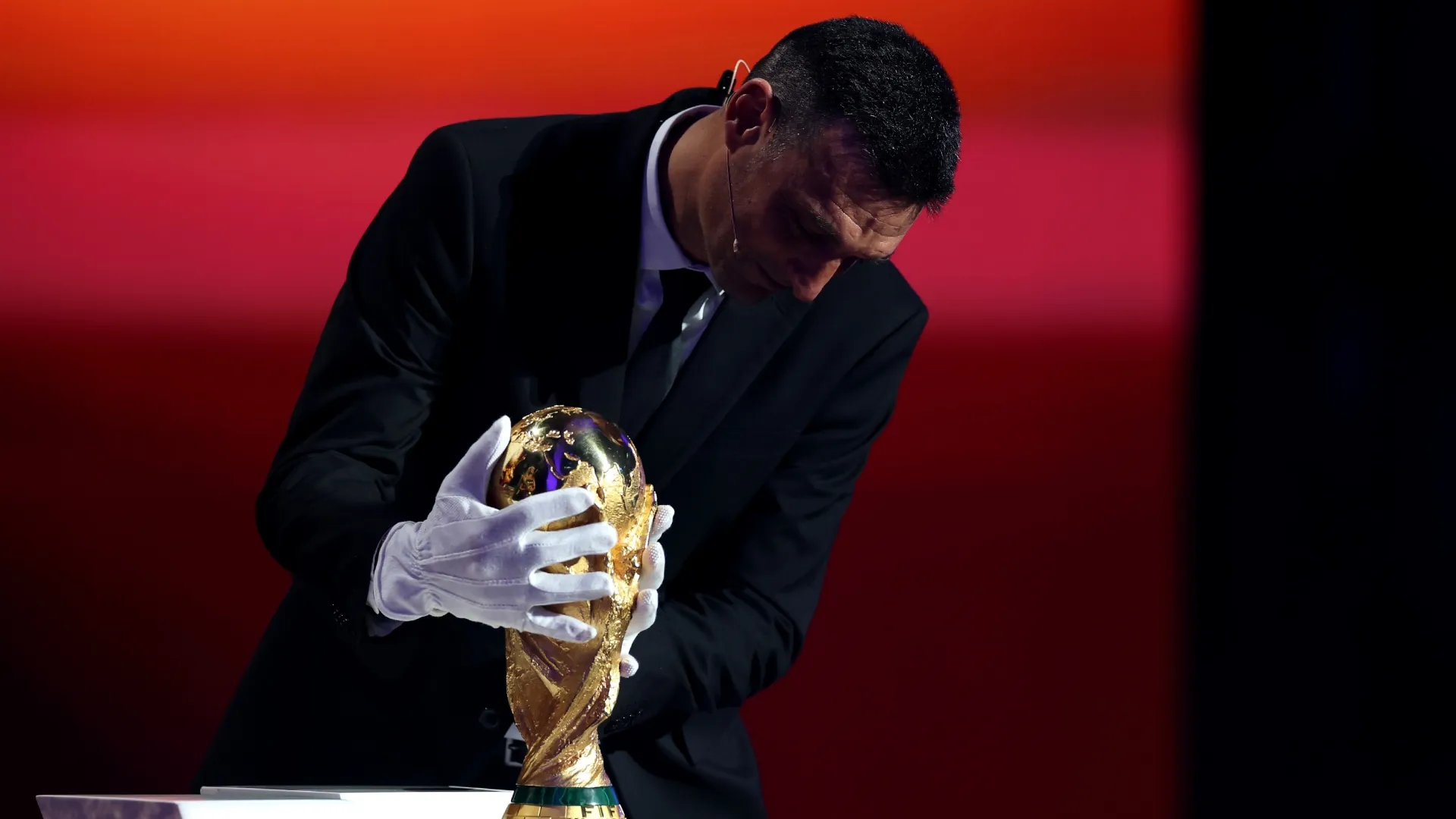 Lionel Scaloni, Head Coach of Argentina, places the FIFA World Cup Trophy on a plinth during the FIFA World Cup 2026 Official Draw.