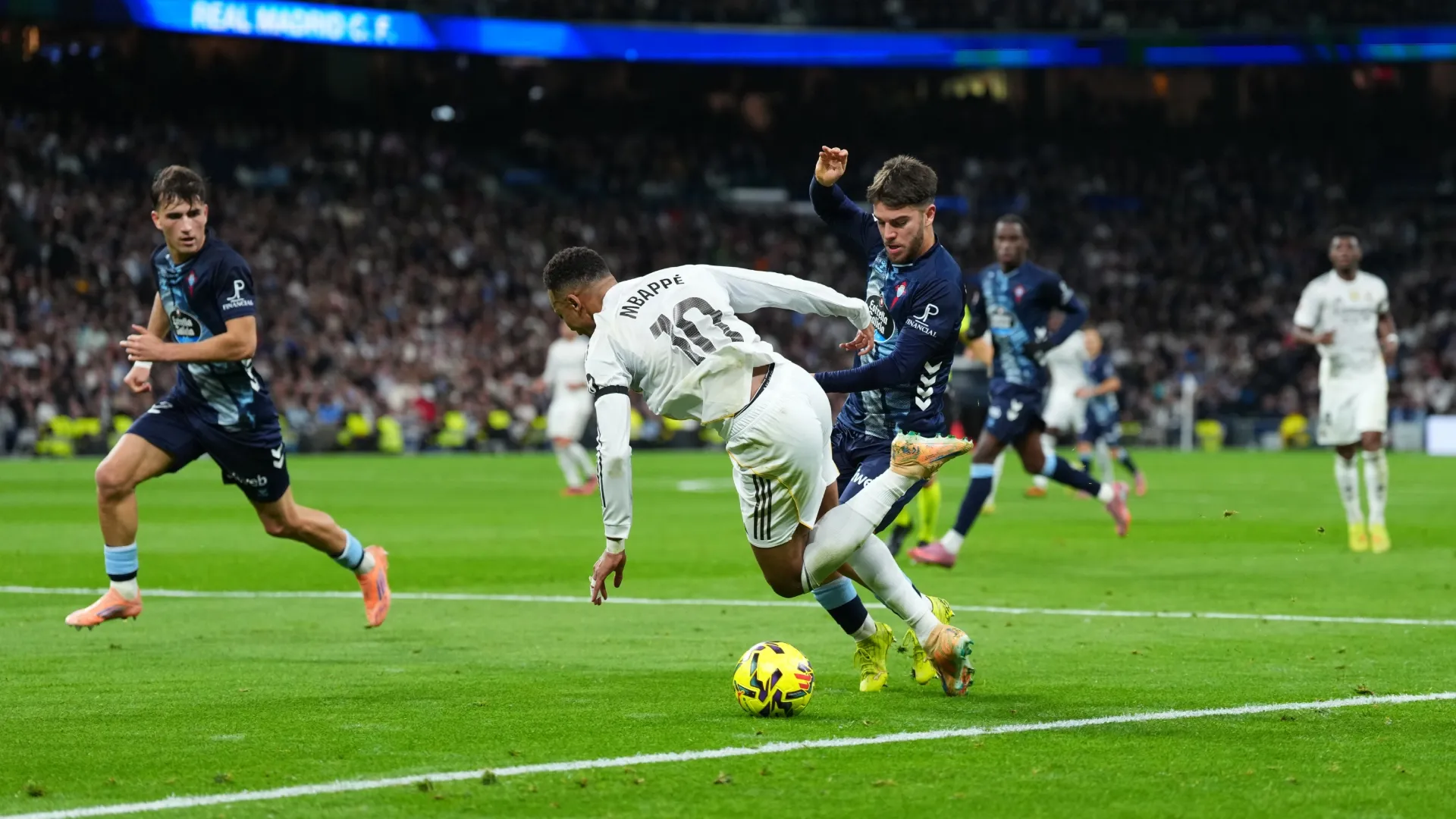 Kylian Mbappe of Real Madrid is challenged by Sergio Carreira of Celta Vigo.