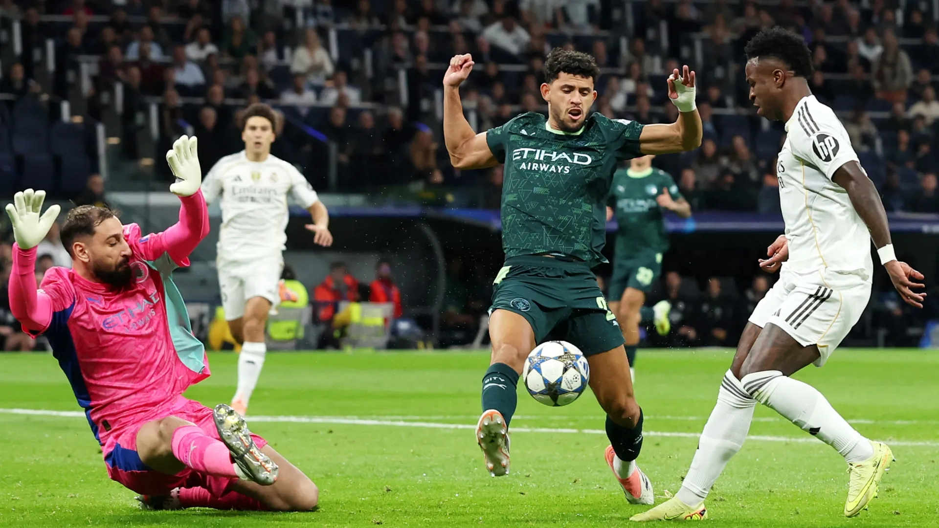Real Madrid's Vinicius Jr and Manchester City's  Matheus Nunes and Gianluigi Donnarumma.