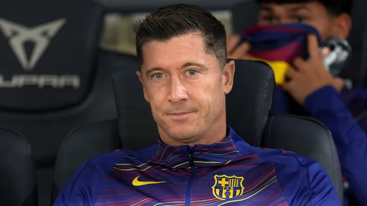 Robert Lewandowski of FC Barcelona looks on from the bench.