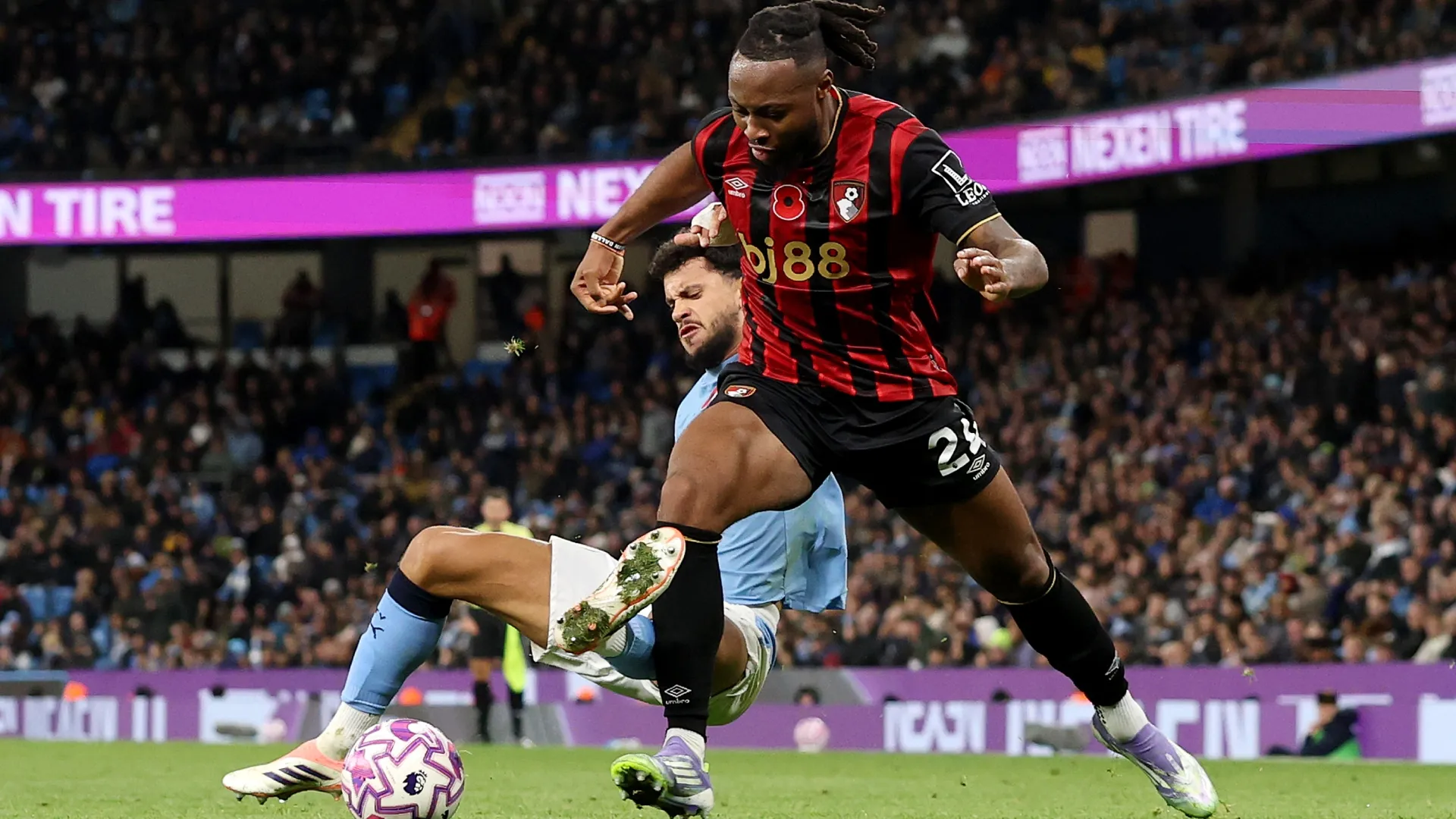 Antoine Semenyo of AFC Bournemouth is challenged by Matheus Nunes of Manchester City.
